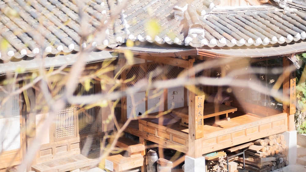 a house with a wooden porch and a roof