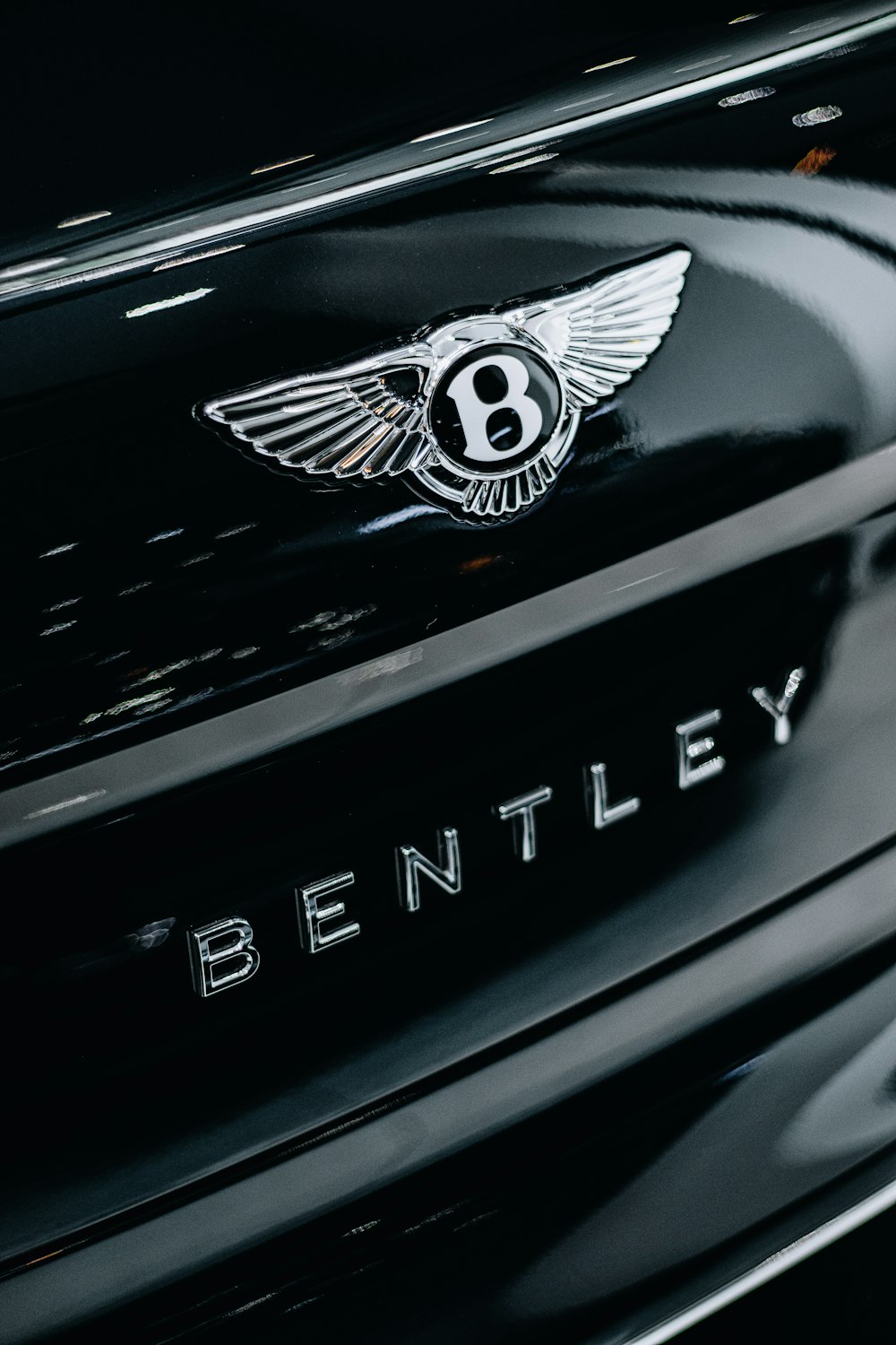 a bentley emblem on the front of a black car