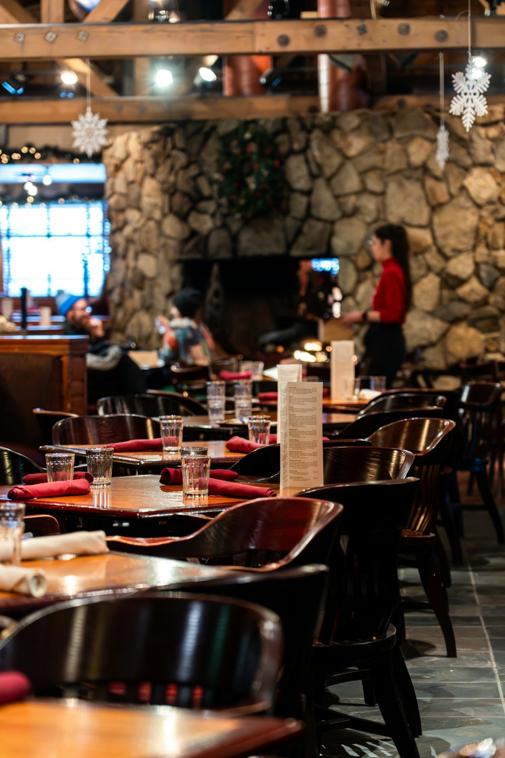 a restaurant filled with lots of wooden tables and chairs