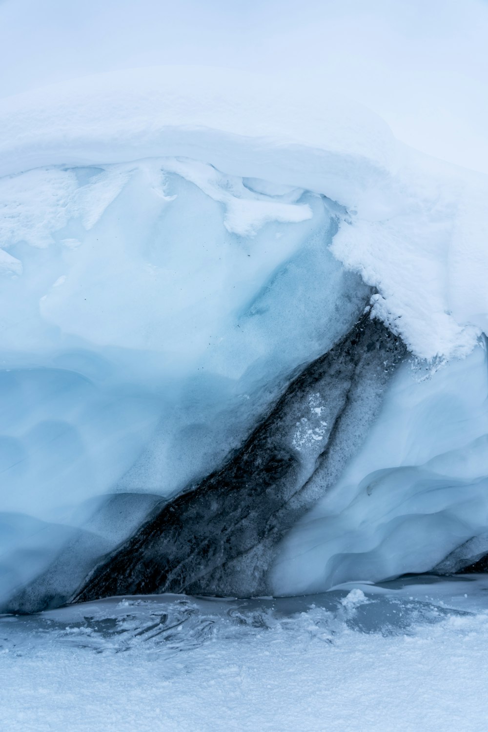 a large ice cave with water coming out of it