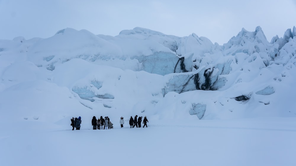 a group of people standing in the snow