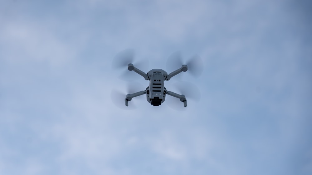 a white and black remote controlled flying in the sky
