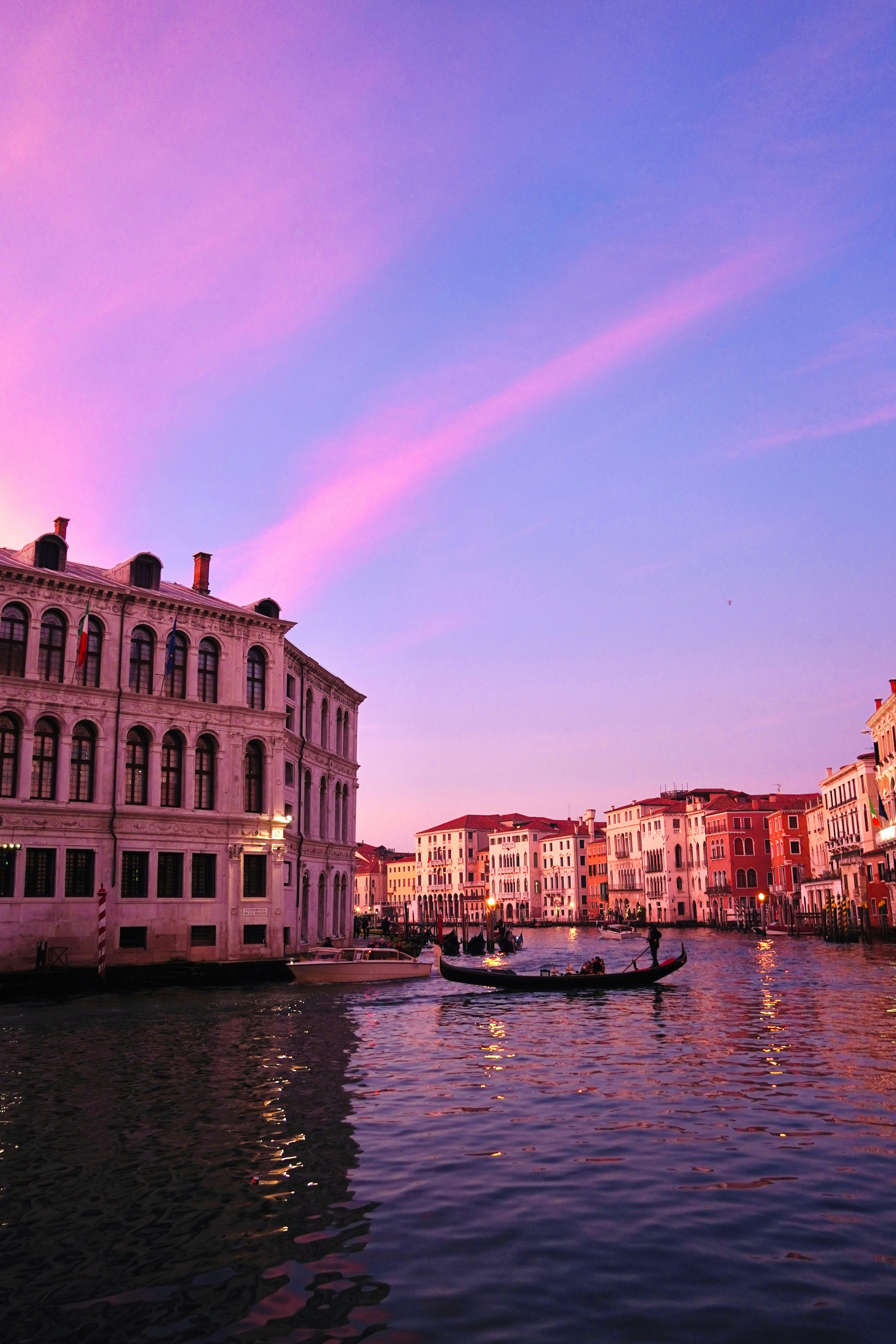 Watercolor style painting of Venice canal at sunset with gondola and warm orange purple tones