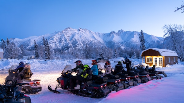 Group snowmobile tour in the mountains