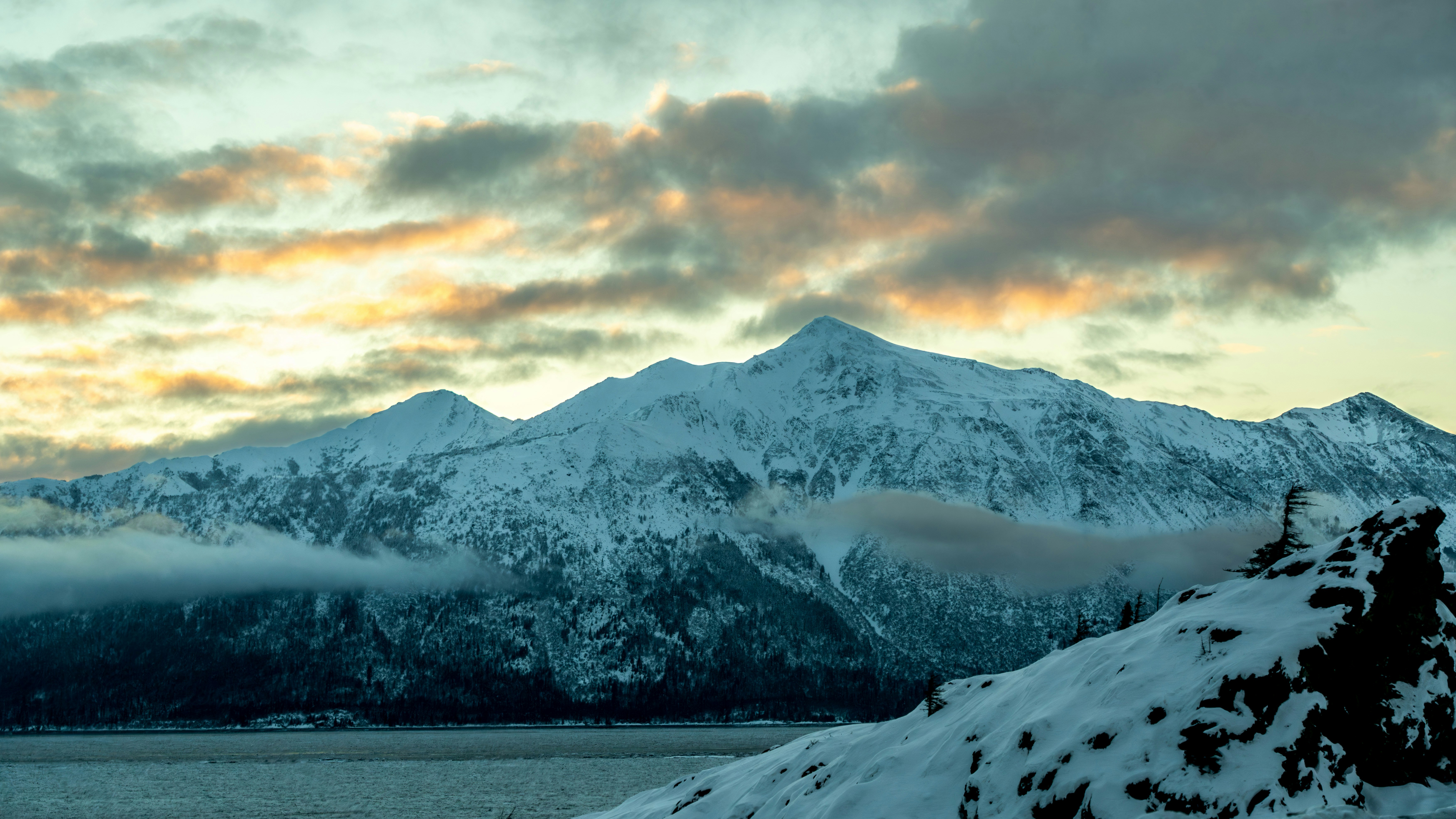 a snow covered mountain with clouds in the sky, Snow Mountain on Seward Highway in Anchorage, AK.