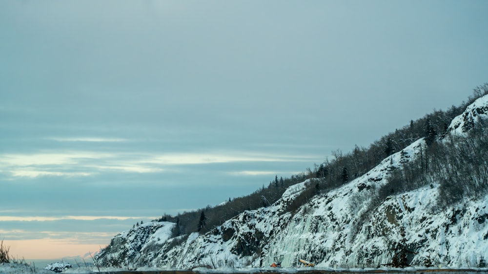 a snow covered mountain with a road going through it