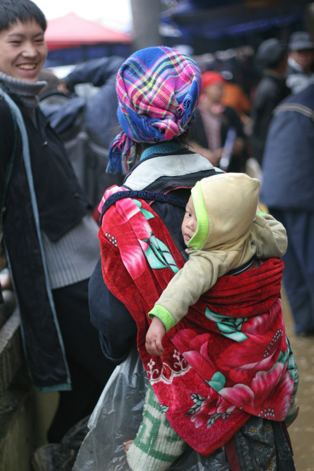 a woman carrying a child on her back