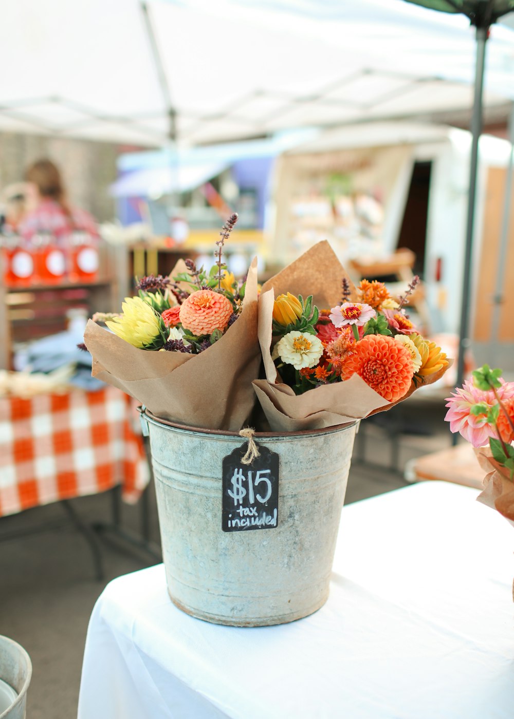 a bucket of flowers sitting on top of a table