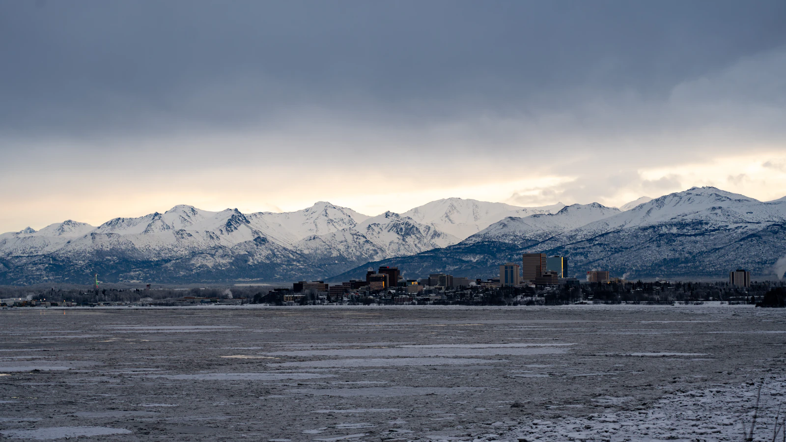 Anchorage along the shore of Knik Arm, under the snow-covered Chugach mountains