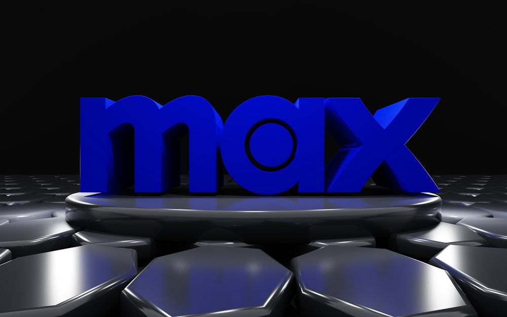 Ein 3D-Bild des Wortes MAX, umgeben von sechseckigen Formen
