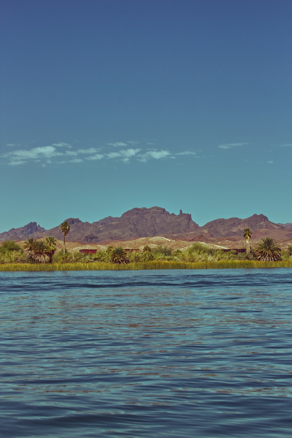 a body of water with mountains in the background