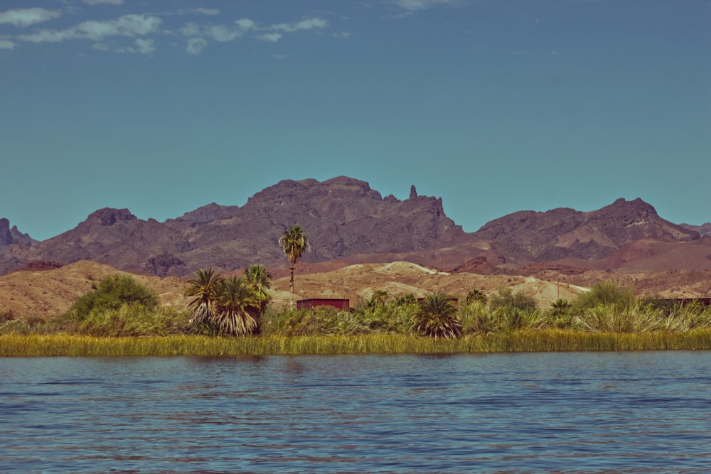 a body of water with mountains in the background