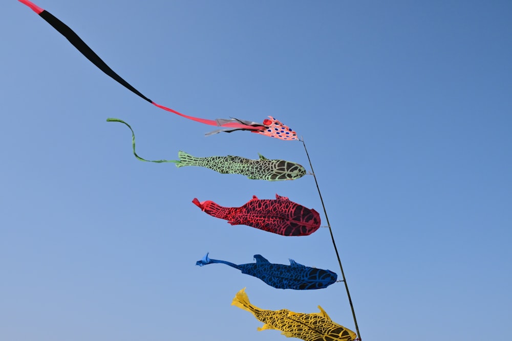 a group of colorful kites flying in the sky