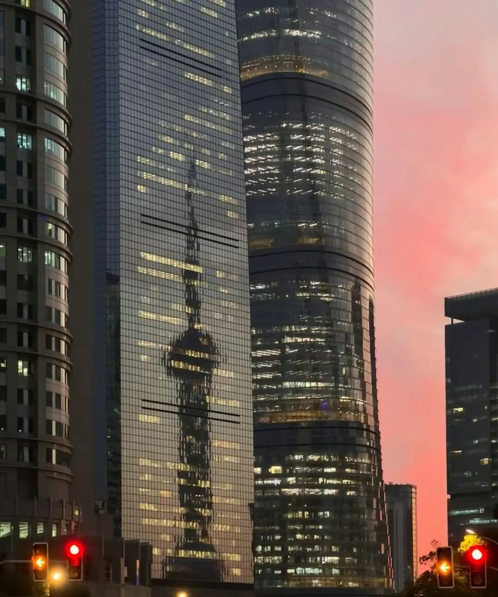 a group of tall buildings in a city at dusk