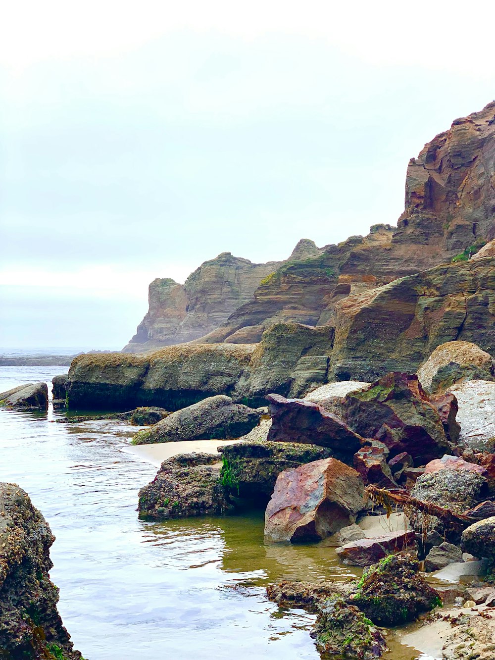 a rocky beach with a body of water