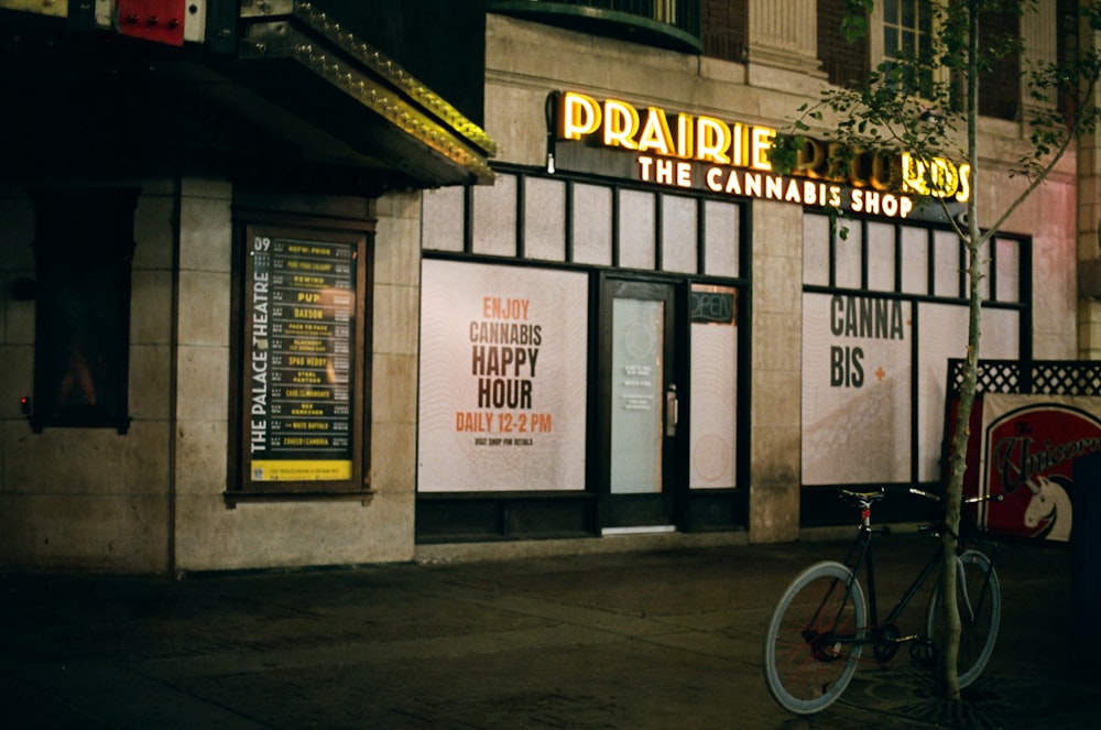 a bike is parked outside of a theater