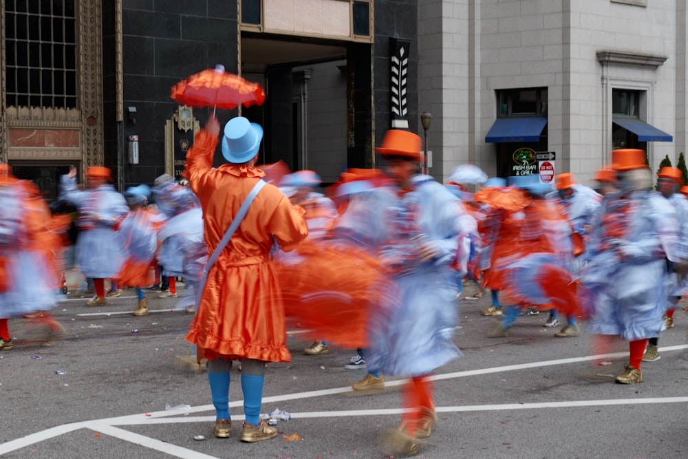 a group of people dressed in orange and blue