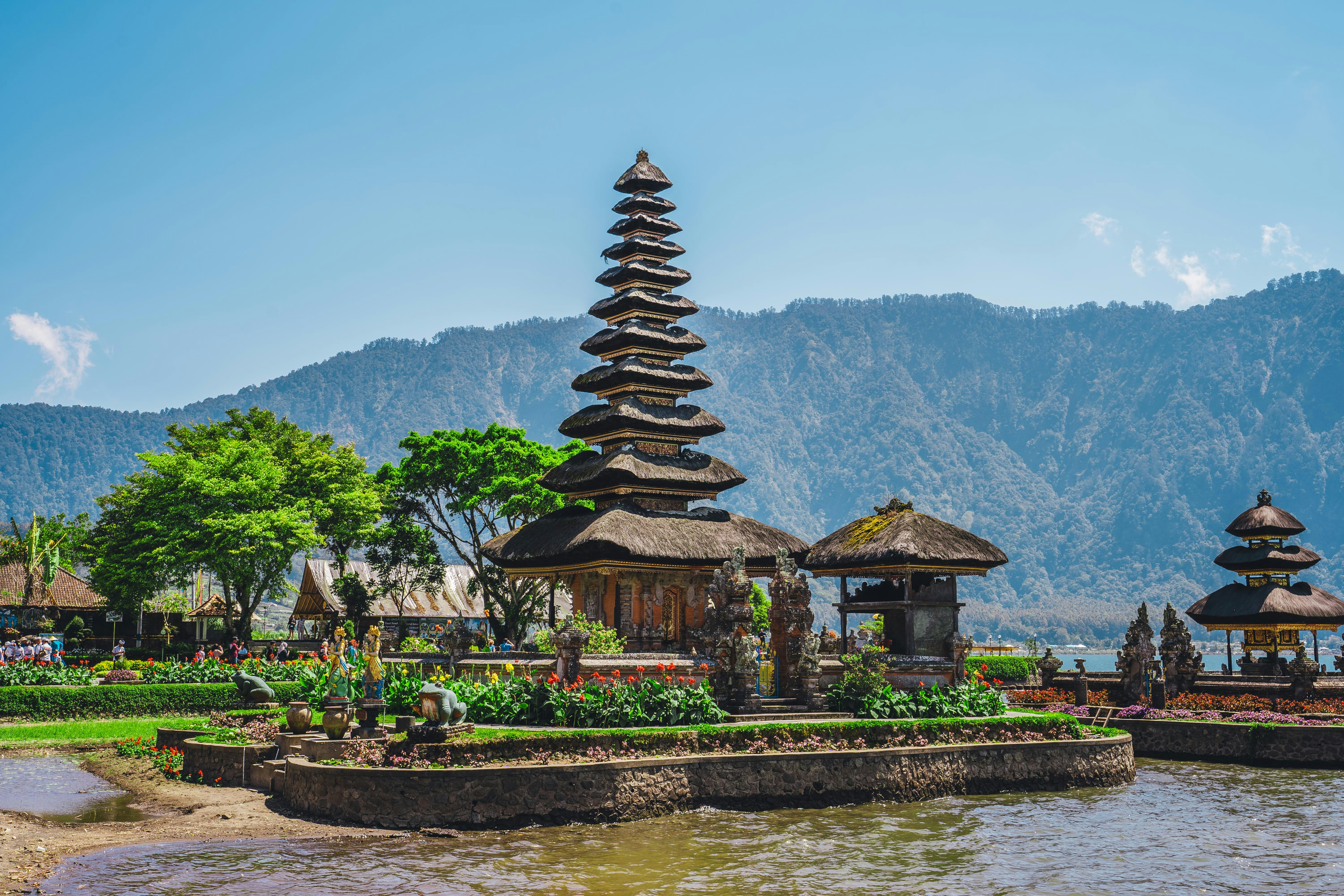 A group of pagodas sitting next to a body of water