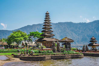 a group of pagodas sitting next to a body of water