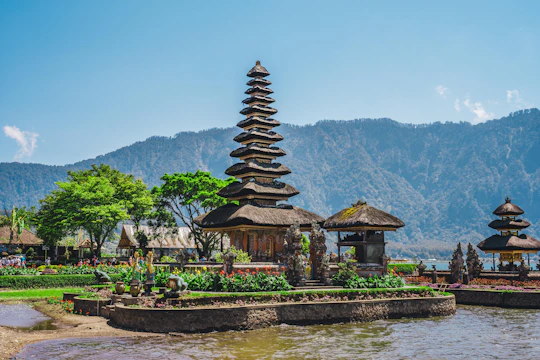 a group of pagodas sitting next to a body of water