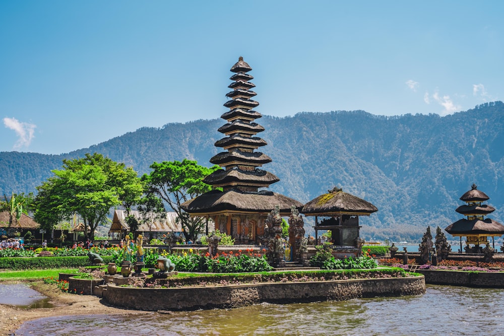 a group of pagodas sitting next to a body of water