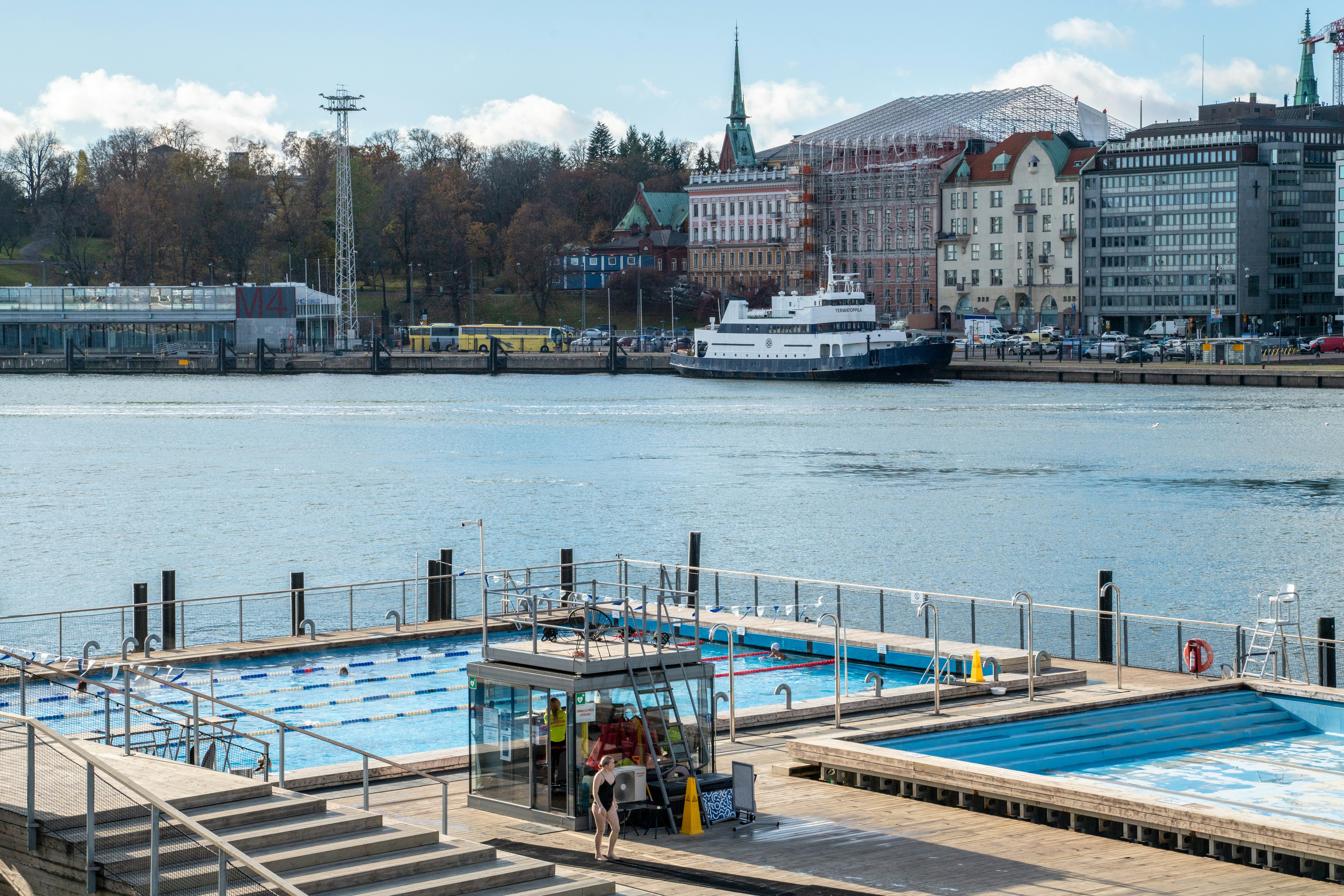 a large body of water with a boat in the background