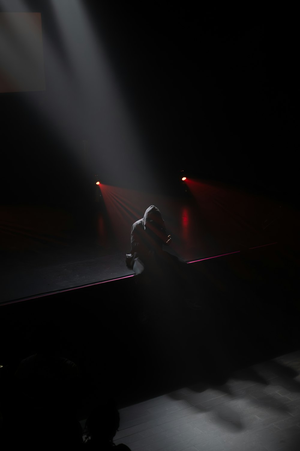 a person standing on a stage in the dark