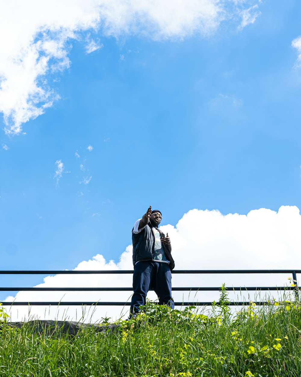 a man standing on top of a lush green field