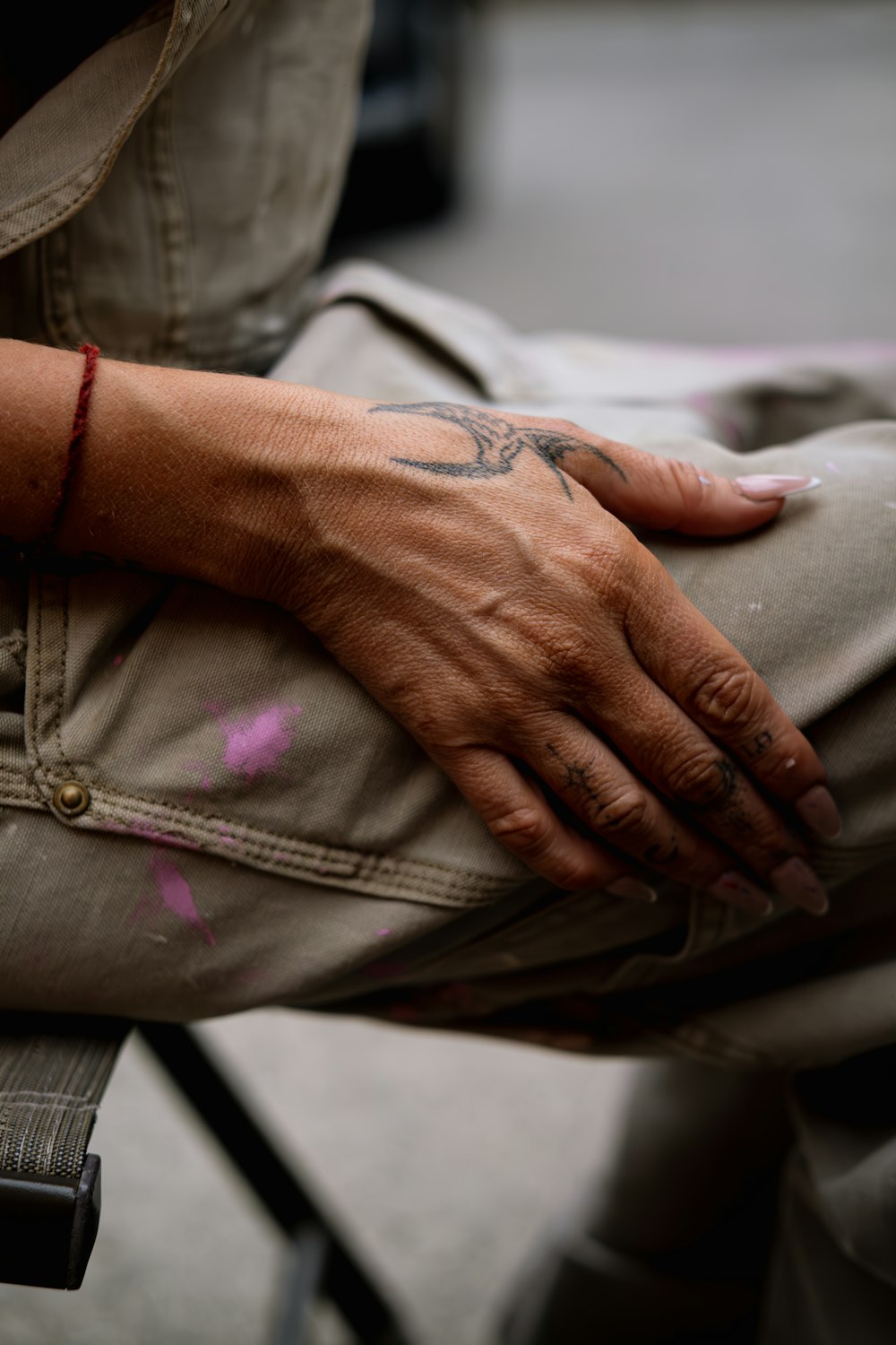 a person with a tattoo on their arm sitting on a chair