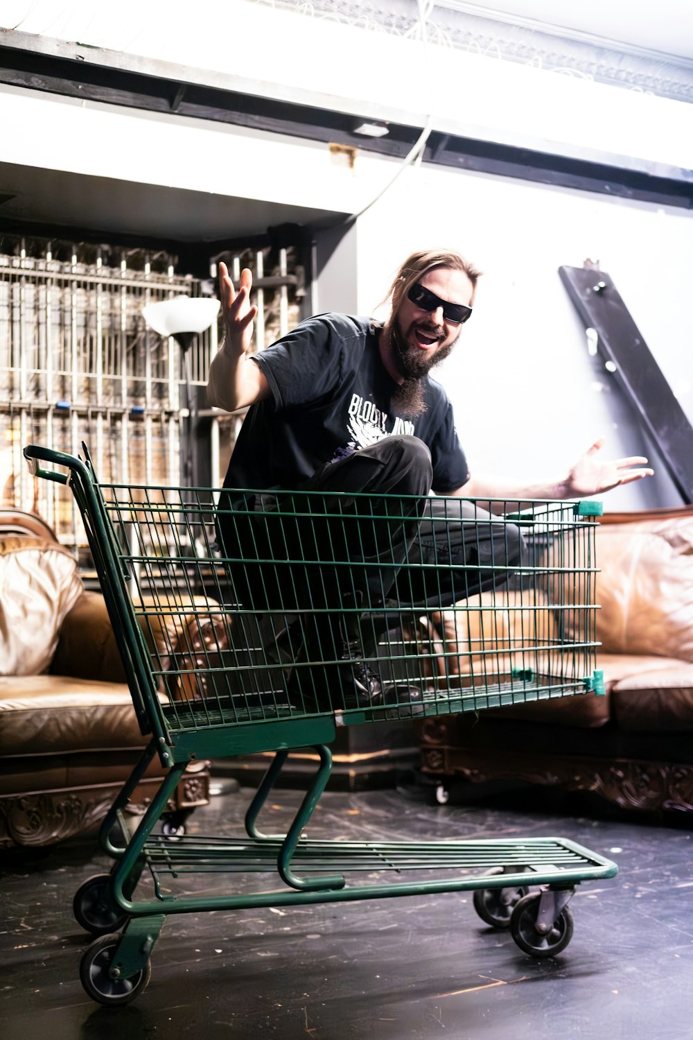 a man is sitting in a shopping cart