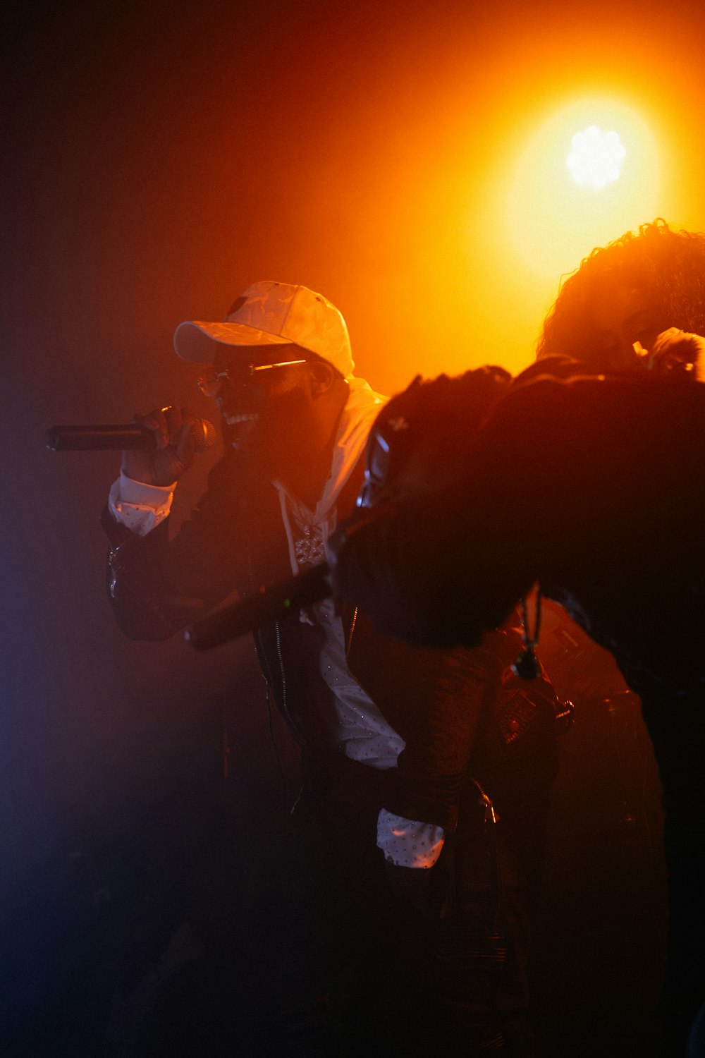 a person with a microphone in a dark room