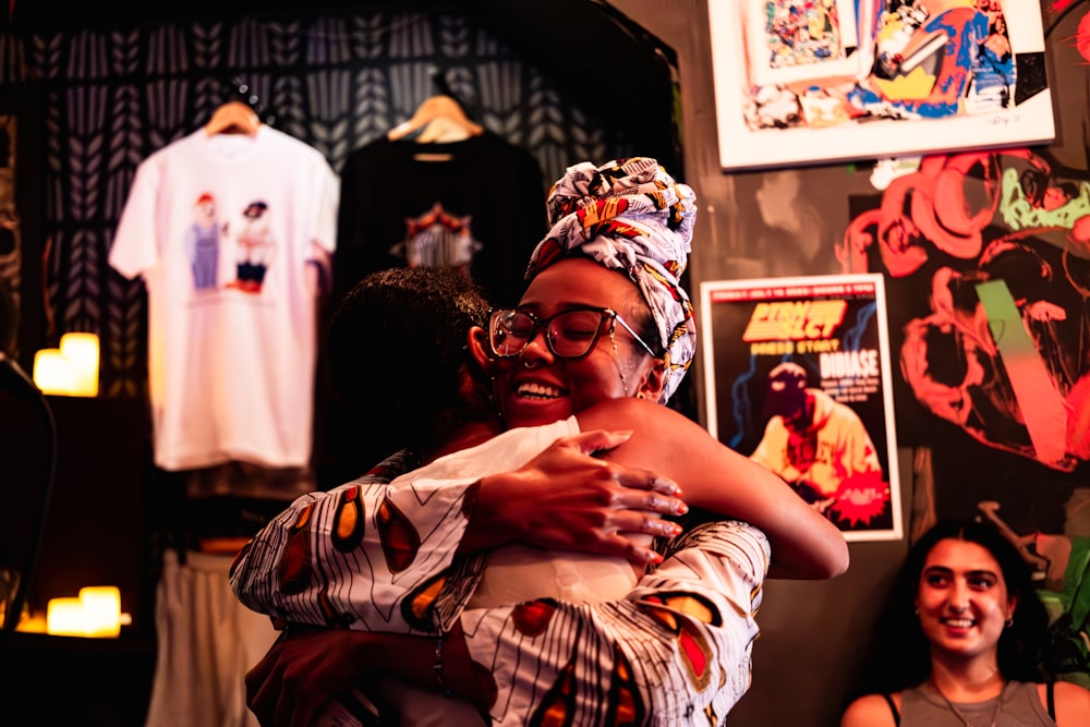 a couple of women hugging each other in a room