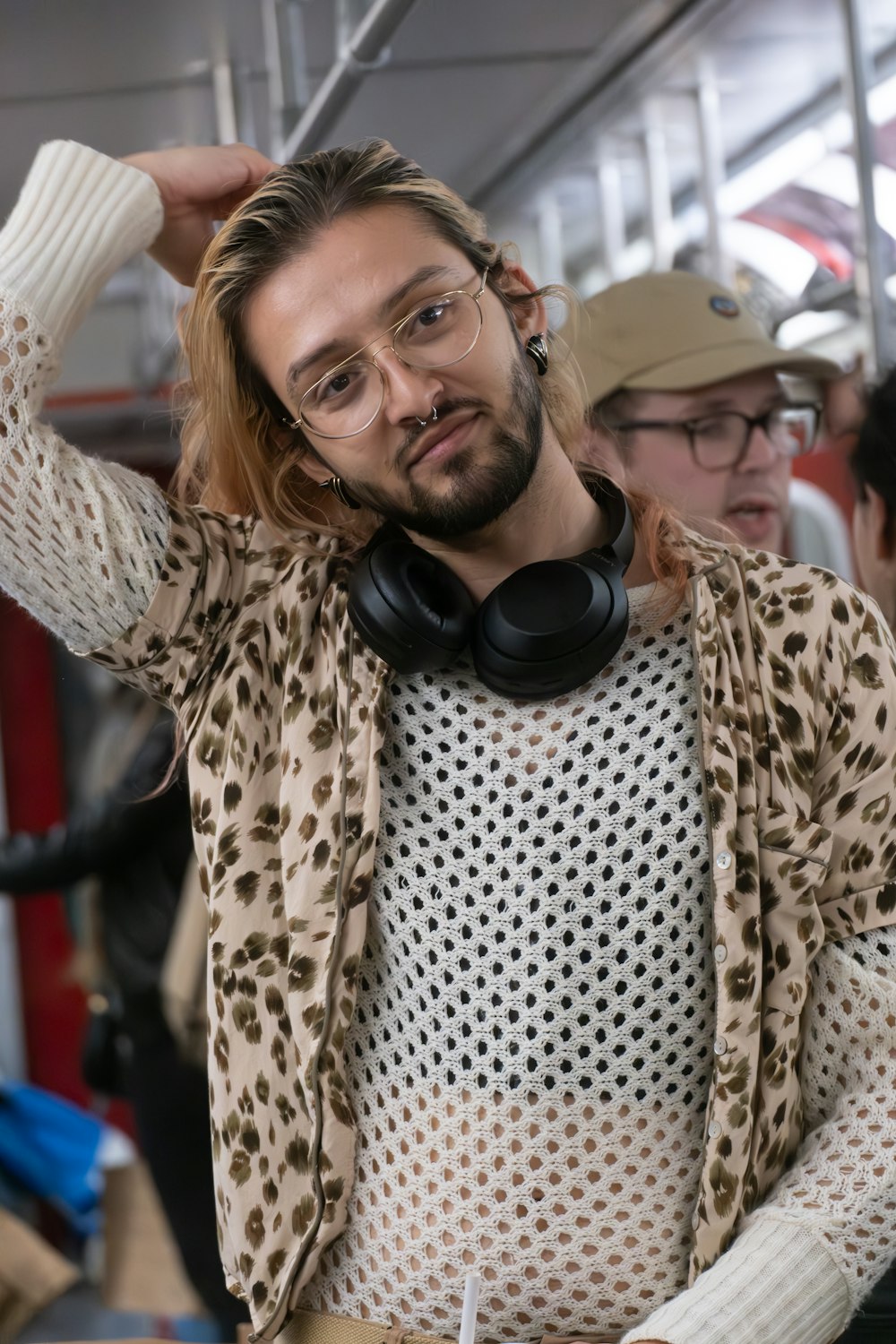 a man wearing headphones and a sweater