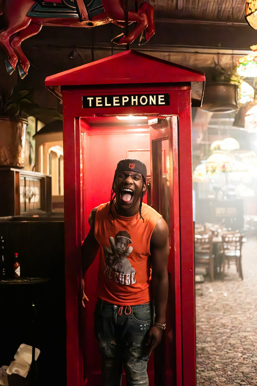 a man standing in a phone booth with his mouth open