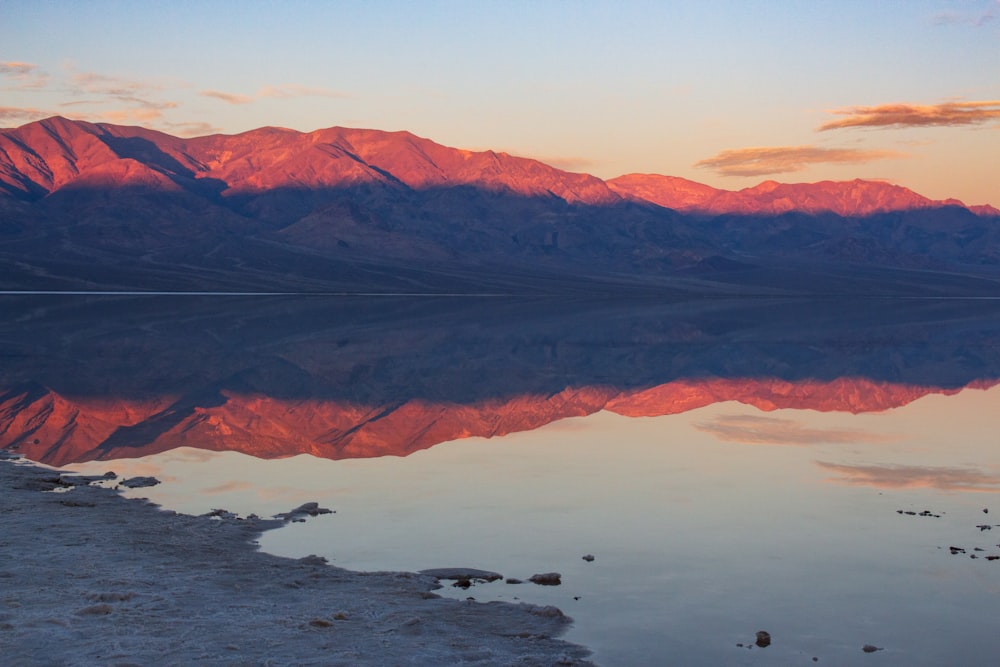 a large body of water with mountains in the background