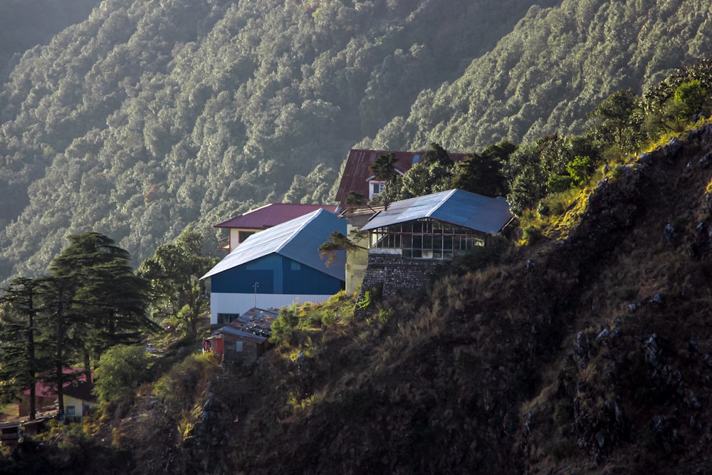 a house on a hill with a mountain in the background