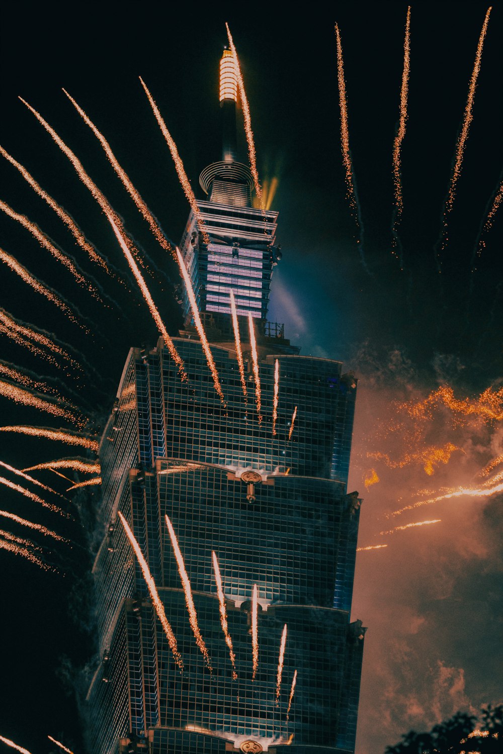 a very tall building with a lot of fireworks in the sky