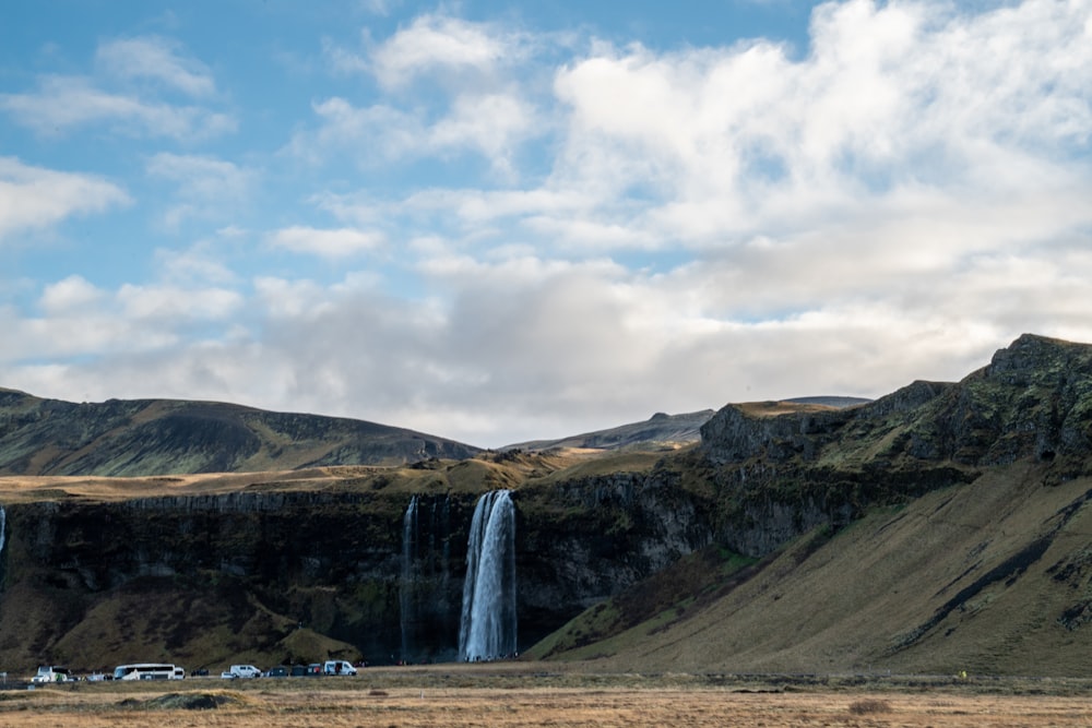 a large waterfall in the middle of a field