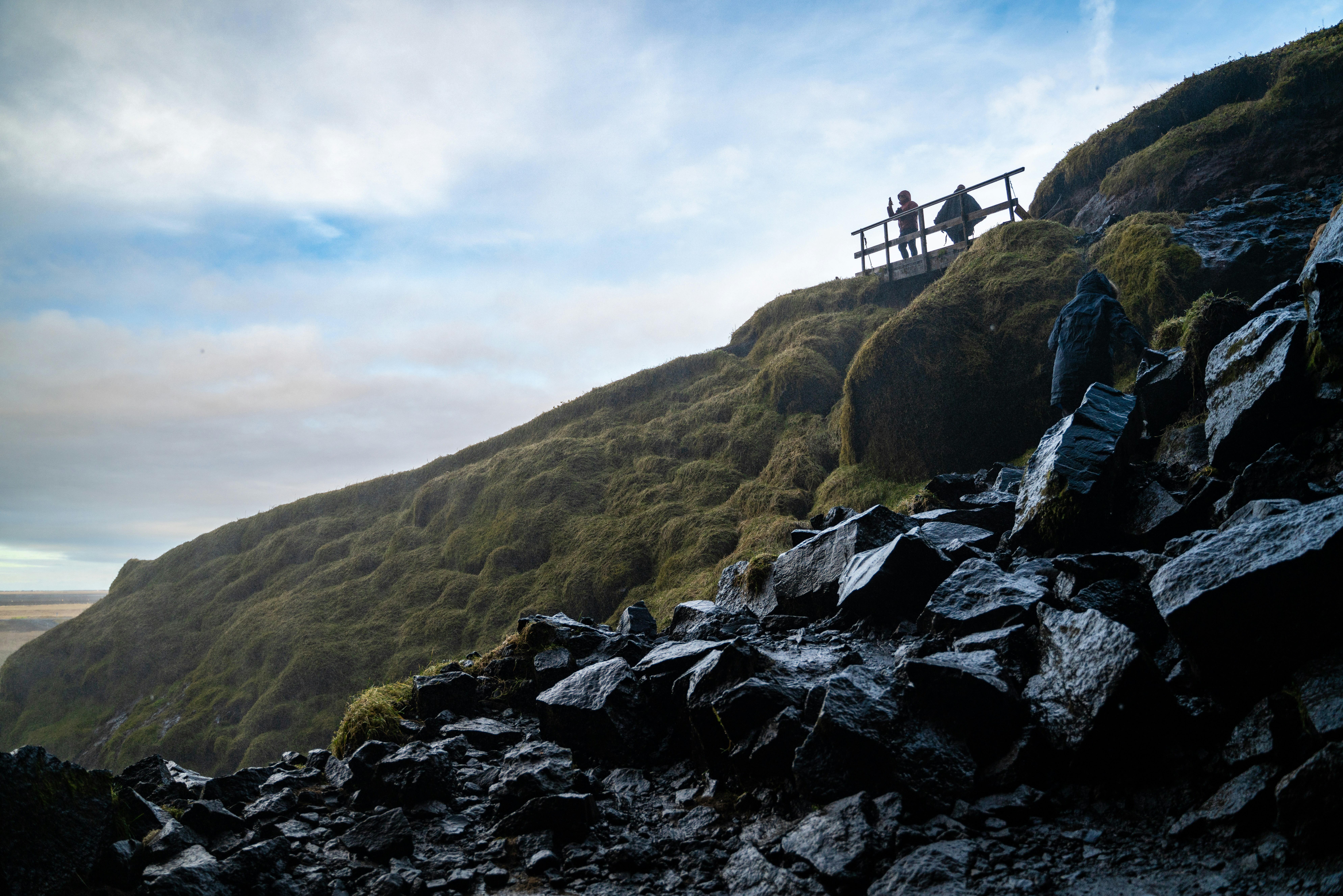 a couple of people sitting on top of a mountain