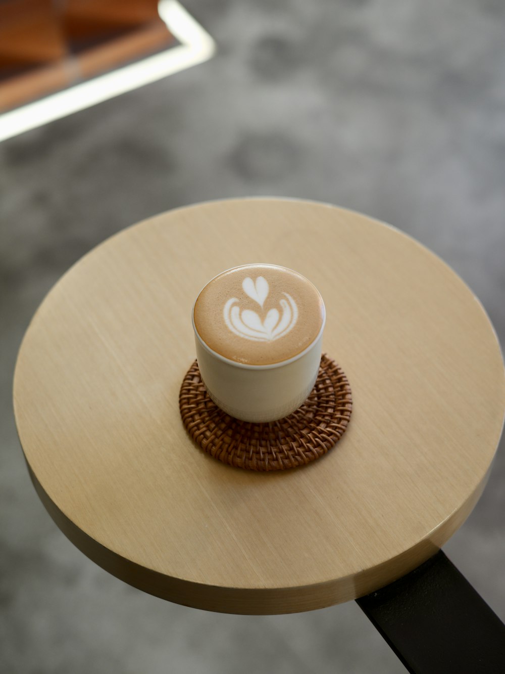 a cappuccino sitting on top of a wooden table