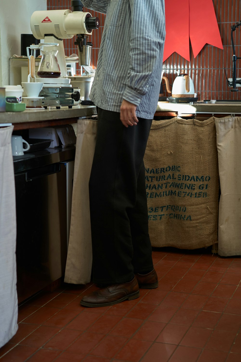 a man standing in front of a coffee machine