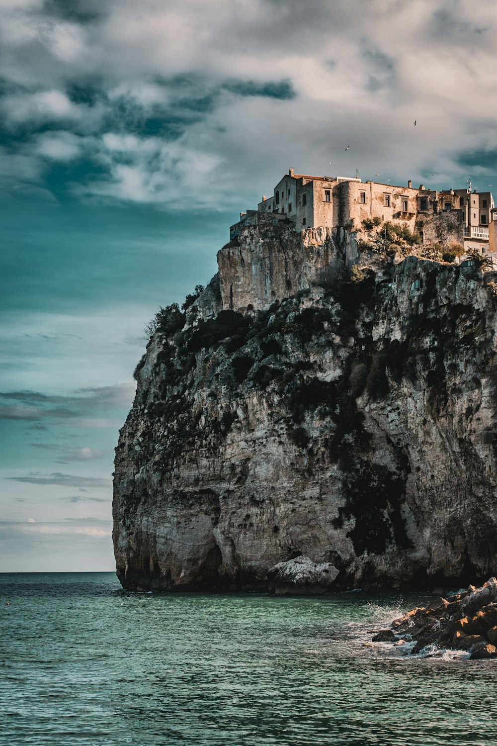 a castle on top of a rock in the ocean