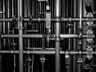 a black and white photo of a bunch of pipes