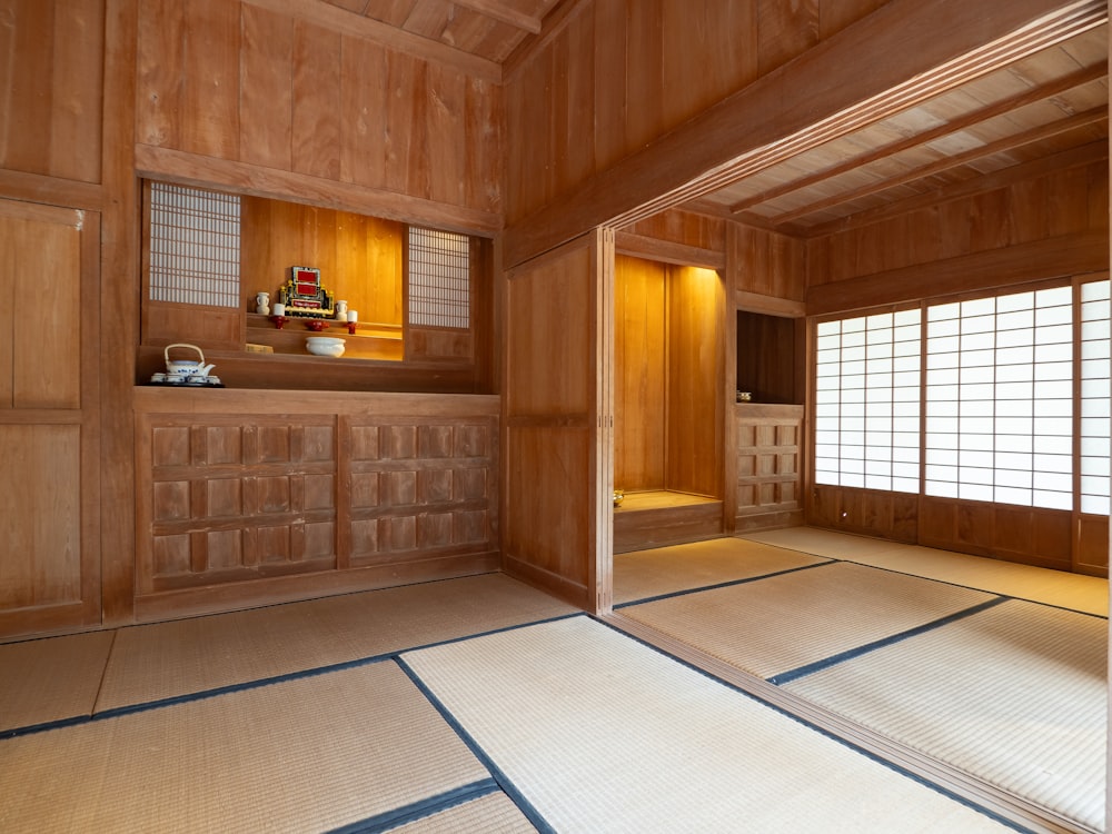 an empty room with wood paneling and a large window