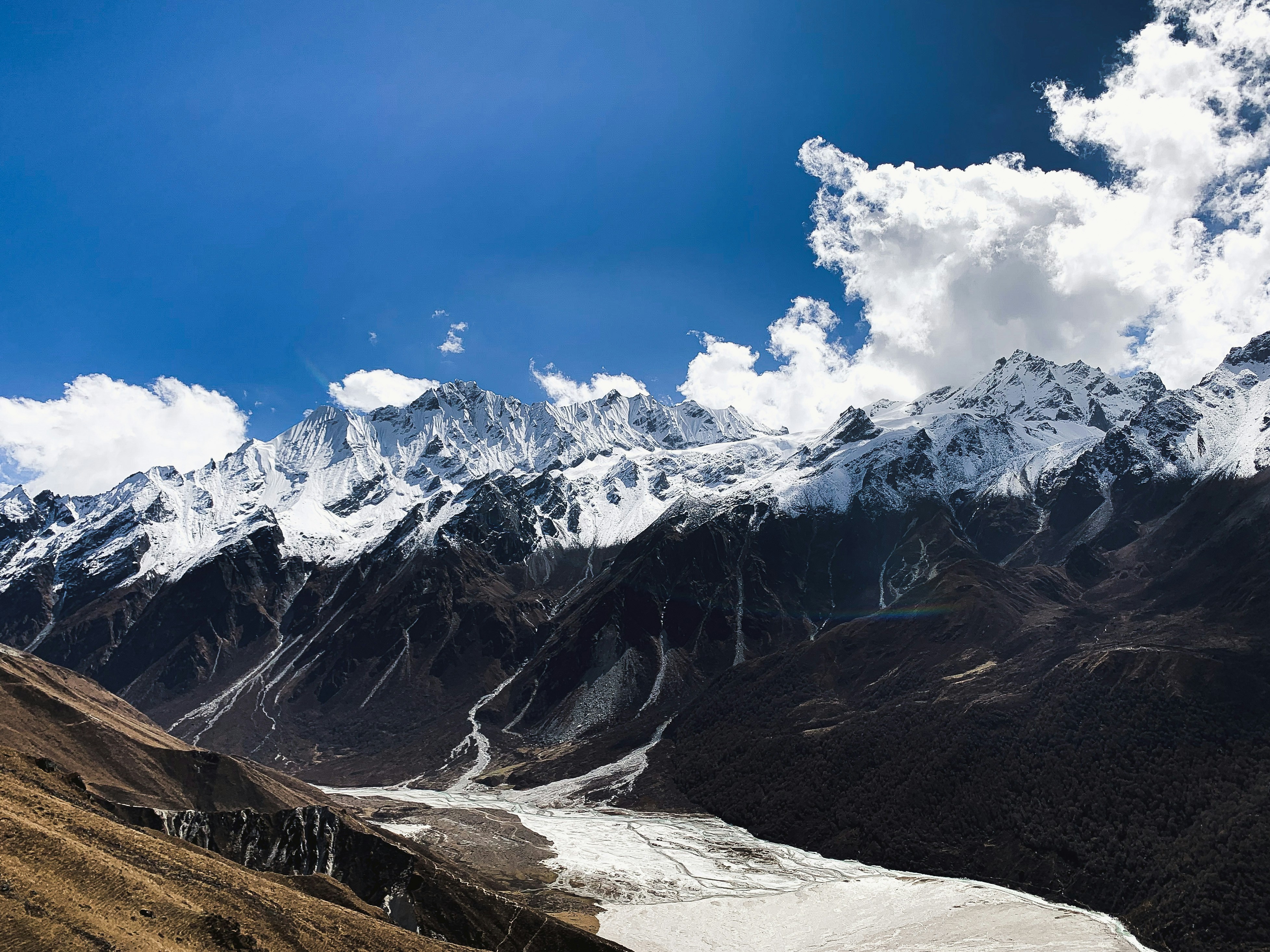 a view of a mountain range with snow on it