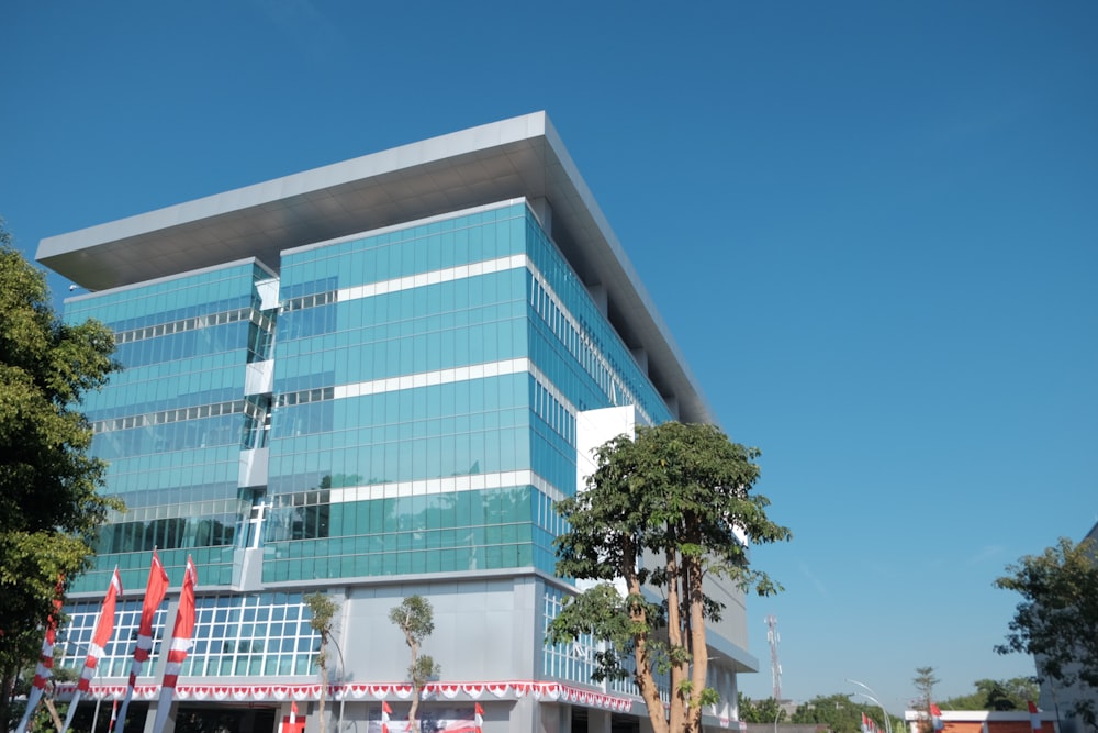 a large building with many windows and trees in front of it