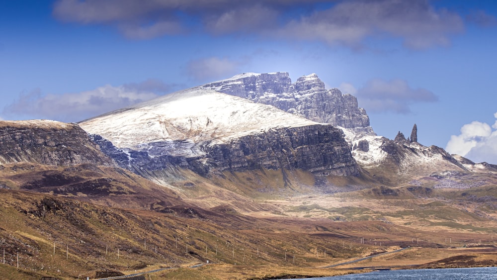 a snow covered mountain with a road running through it