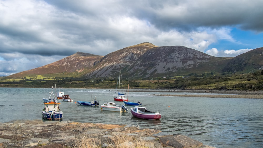 a group of boats floating on top of a lake