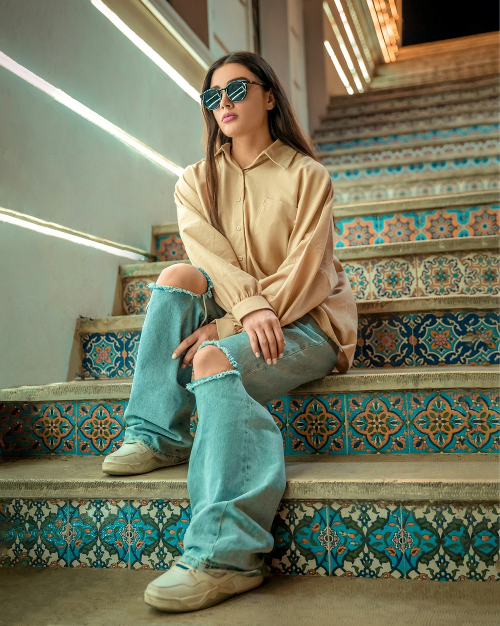 a woman sitting on a set of stairs