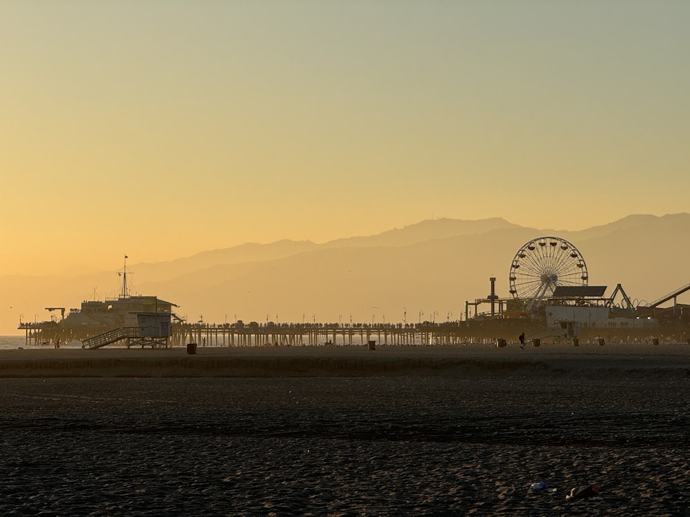 a ferris wheel sitting on top of a sandy beach